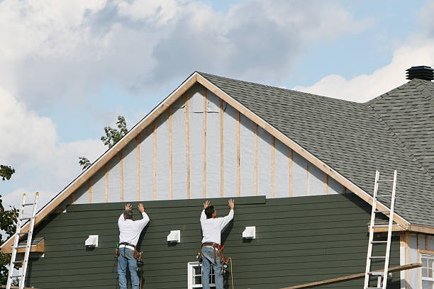 Professional Storm Damage Siding Repair technician working in Munson, PA